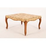 A Victorian walnut square stool with serpentine frieze on moulded cabriole legs with pointed feet,