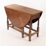 A mahogany two-flap gateleg table on baluster turned legs and square stretchers,