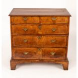 An 18th Century walnut chest of three long and two short drawers on bracket feet,