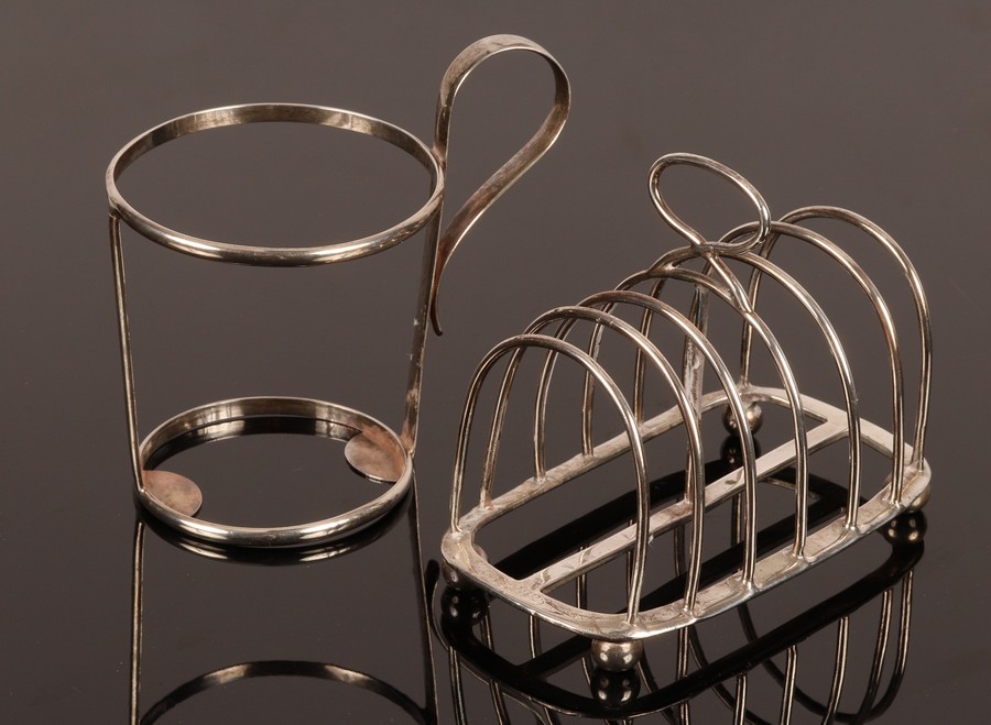 A Victorian silver seven-bar toast rack, London 1886 and a silver holder for a beaker,