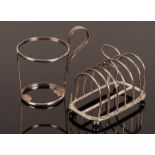A Victorian silver seven-bar toast rack, London 1886 and a silver holder for a beaker,