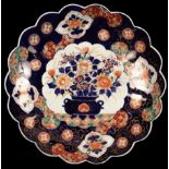 A Japanese Imari plate of scalloped shape,