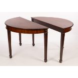 A pair of mahogany side tables with carved borders and plain frieze, on stepped fluted taper legs,