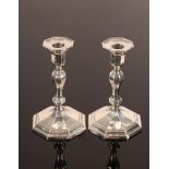 A pair of Victorian silver candlesticks, Sheffield 1893, of knopped octagonal form, crested,