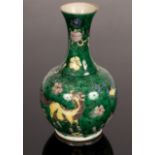 A Kangxi style famille verte vase, decorated green and black swirls, a purple and yellow horse,