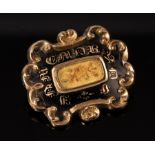 An early Victorian mourning brooch, in yellow metal and black enamel,