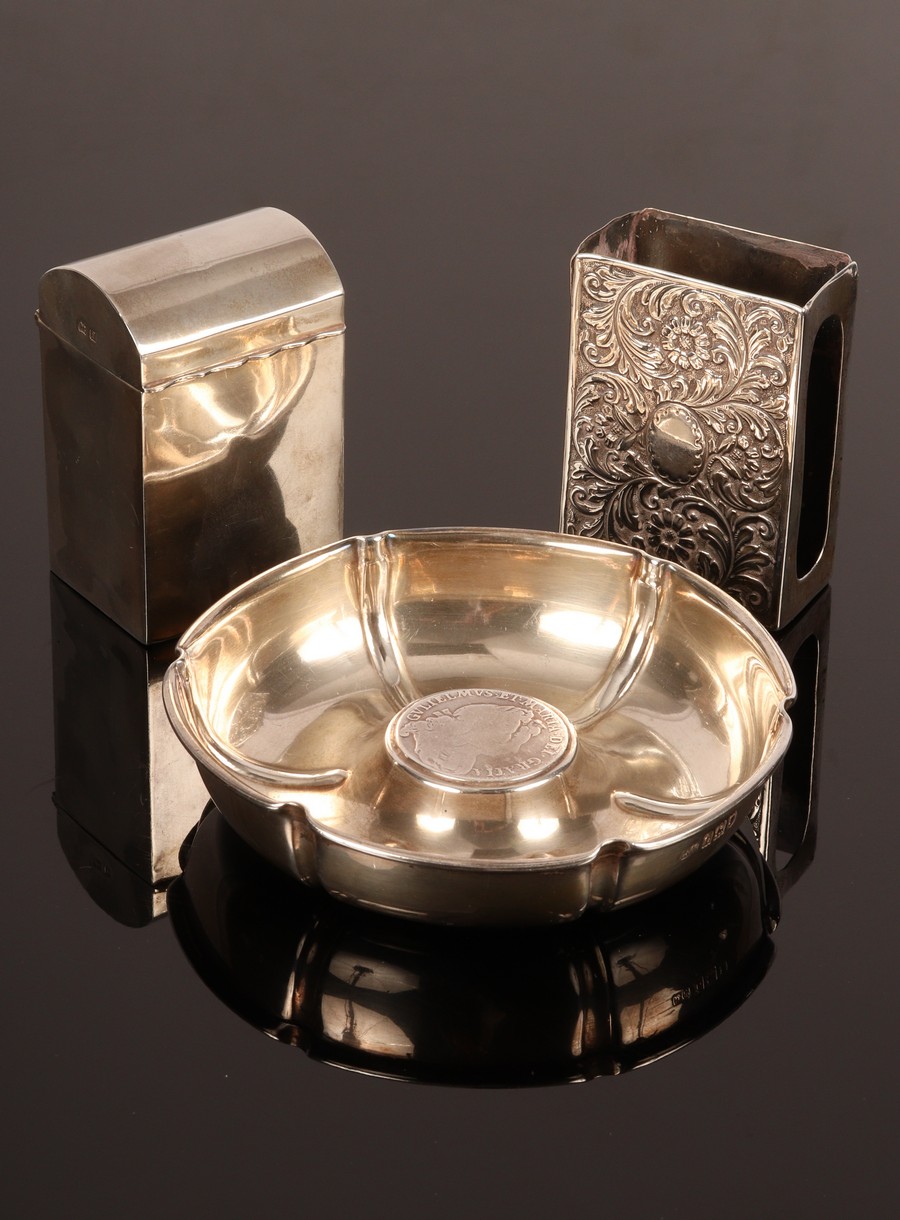 A hexagonal silver ashtray, London 1914, the central boss set a William & Mary coin, 12cm diameter,