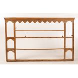 A pine hanging shelf with shaped apron to the cornice,
