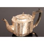 A silver teapot, London circa 1910, (marks rubbed), monogrammed,