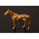 A 9ct yellow gold horse brooch, Alabaster & Wilson, the horse modelled standing, 32mm long,