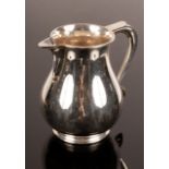 A Georgian style silver beer jug, Edward Barnard & Sons, London 1969, of plain form,