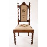 A child's Victorian rosewood chair with spiral turned uprights and legs with later needlework