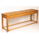 A pine serving table on square legs, united by square stretchers,