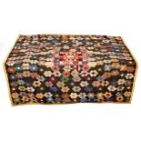 A Victorian patchwork quilt, finely decorated all over flowerheads with hexagonal petals,