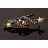 A diamond and pearl bar brooch of scroll form with pearl to each end,