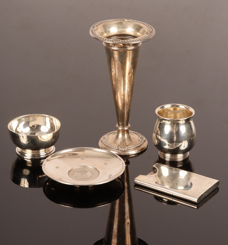 A small quantity of silver including a coin set ashtray, R & D, London 2000, 10cm diameter,