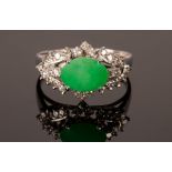 A jade and diamond dress ring, set in 18k white gold, the oval jade measuring 9.