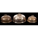 A set of three silver plated food domes, each with leaf scroll handle, crested, the largest 35.