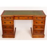 A Victorian mahogany breakfront pedestal desk, fitted a surround of nine drawers,
