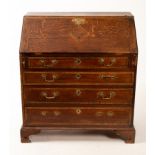 A George III oak bureau fitted beneath the fall and with four drawers under, on ogee bracket feet,