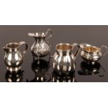 Four silver jugs, including one of baluster shape, London 1912 and another of squat circular form,