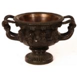 A late 19th Century bronze model of the Warwick vase, twin wrythen handles and Bacchic ornament,