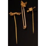 Three stick pins of hunting interest, one with fox mask terminal,