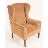 A wing back armchair on square tapering front legs with castors, 101cm high,