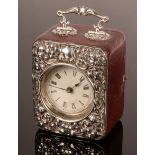 An embossed silver mounted travelling clock case with handle, 13.