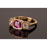 A ruby and diamond three-stone ring, set in 18ct yellow gold,