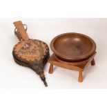 A pair of leather covered bellows decorated a street scene to one side, 64cm long,