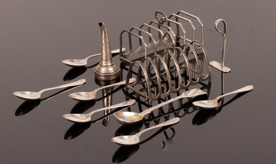 Two silver toast racks, six feather edged silver teaspoons,