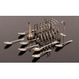 Two silver toast racks, six feather edged silver teaspoons,
