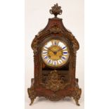 A 19th Century French mantel clock of Rococo design in a brass and tortoiseshell case,