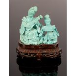 A 20th Century carved turquoise statue depicting two female musicians playing traditional