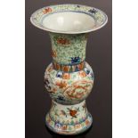 A 20th Century Chinese famille rose porcelain vase, Gu, decorated with dragons in panels,