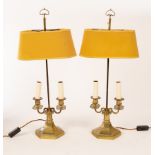 A pair of brass two-branch table lamps, on hexagonal bases with adjustable shades,