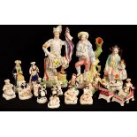 A group of Staffordshire porcelain figures of 'Turks' including a pair reclining on a chaise,