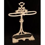 A two-division white painted cast iron umbrella stand with removable drip tray,
