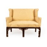 A two-seater sofa of Chinese Chippendale design with blind fret decoration,