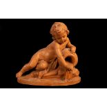 A large 19th Century terracotta figure of a reclining cherub pouring water from a flagon,