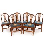 Six mahogany splat back dining chairs, the needlework cushions depicting flowers,