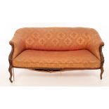 An upholstered sofa with scroll arms on cabriole front legs,