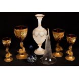 A set of four graduated ruby glass and gilt goblets on dolphin stems, an opaque white glass vase,