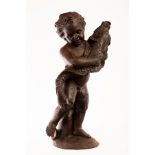 A cast iron fountain figure of a cherub holding a dolphin,