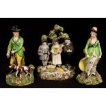 A Staffordshire pearlware group 'The Tithe Pig', 17cm high and a pair of hunter and huntress,