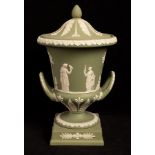 A Wedgwood sage jasper two-handled urn-shaped vase and cover, decorated with Classical figures,