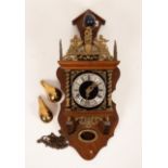 A reproduction Dutch wall clock with brass mounts and weights,