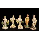 Five small pearlware figures of cherubs, three with flower baskets and two holding parakeets,