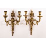 A pair of 19th Century ormolu two-branch wall lights of Louis XVI style with urn finials and